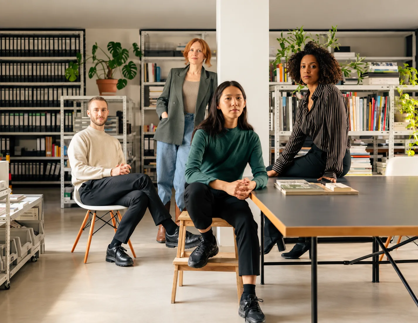 Four people together in a workspace.